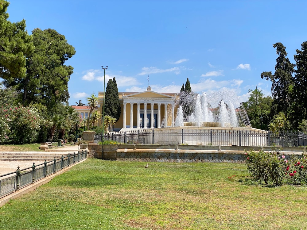 water fountain in front of white building