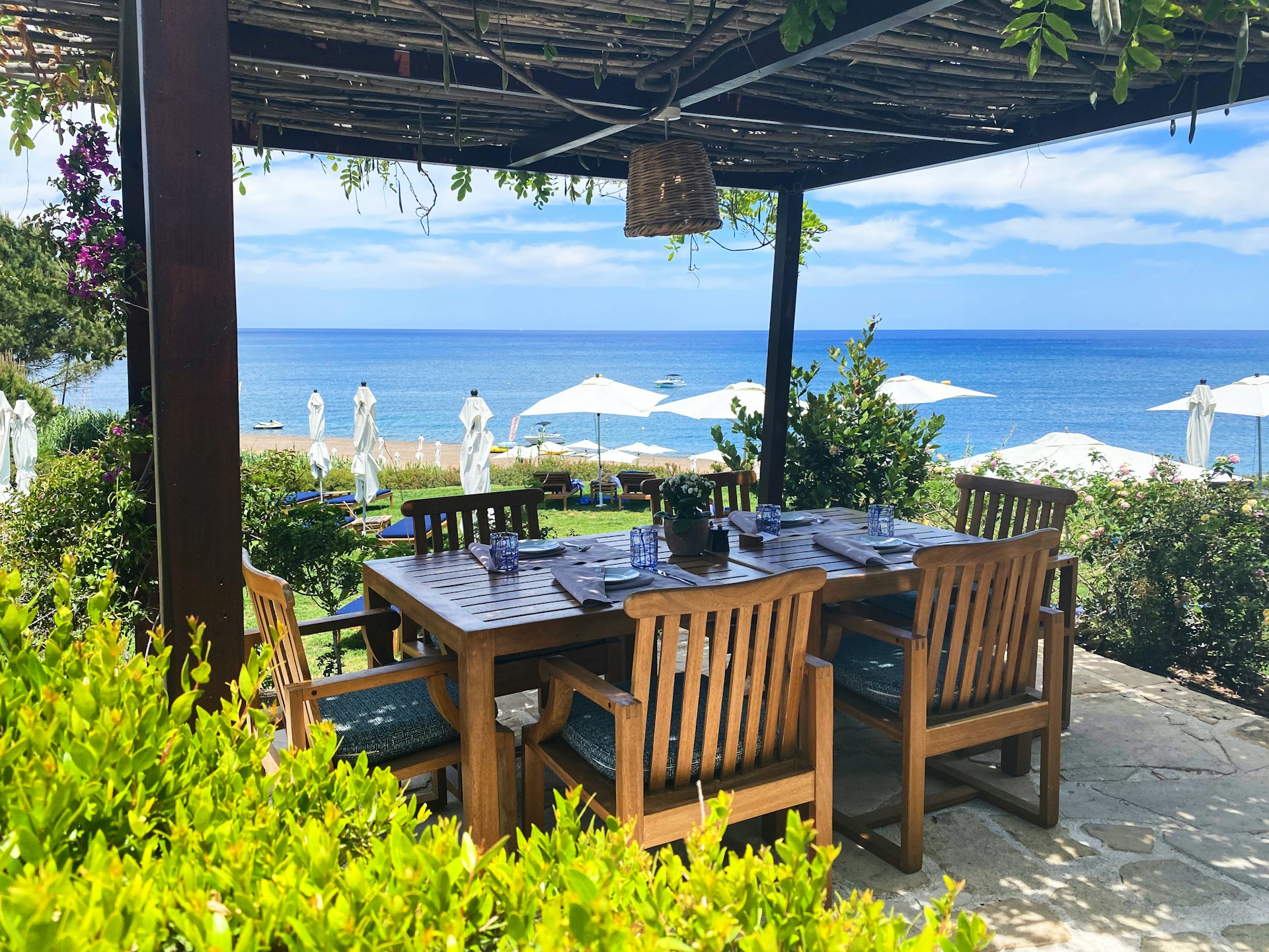 brown wooden table with chairs and table on beach during daytime