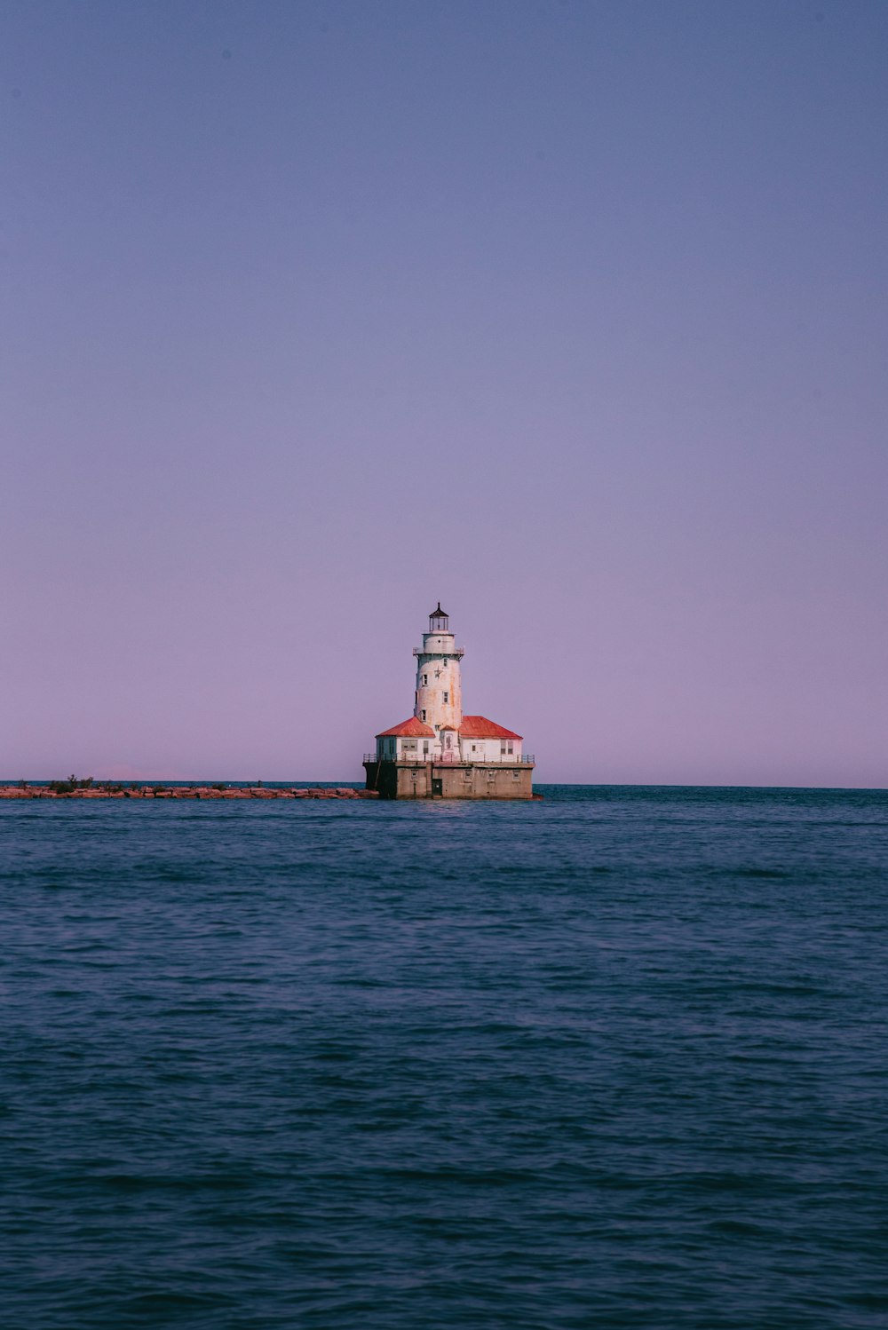 white and brown concrete building on sea during daytime