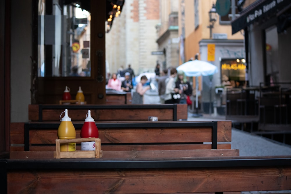 people sitting on brown wooden bench during daytime