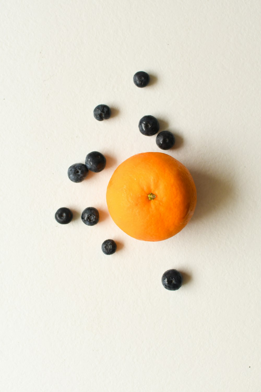 orange fruit on white surface