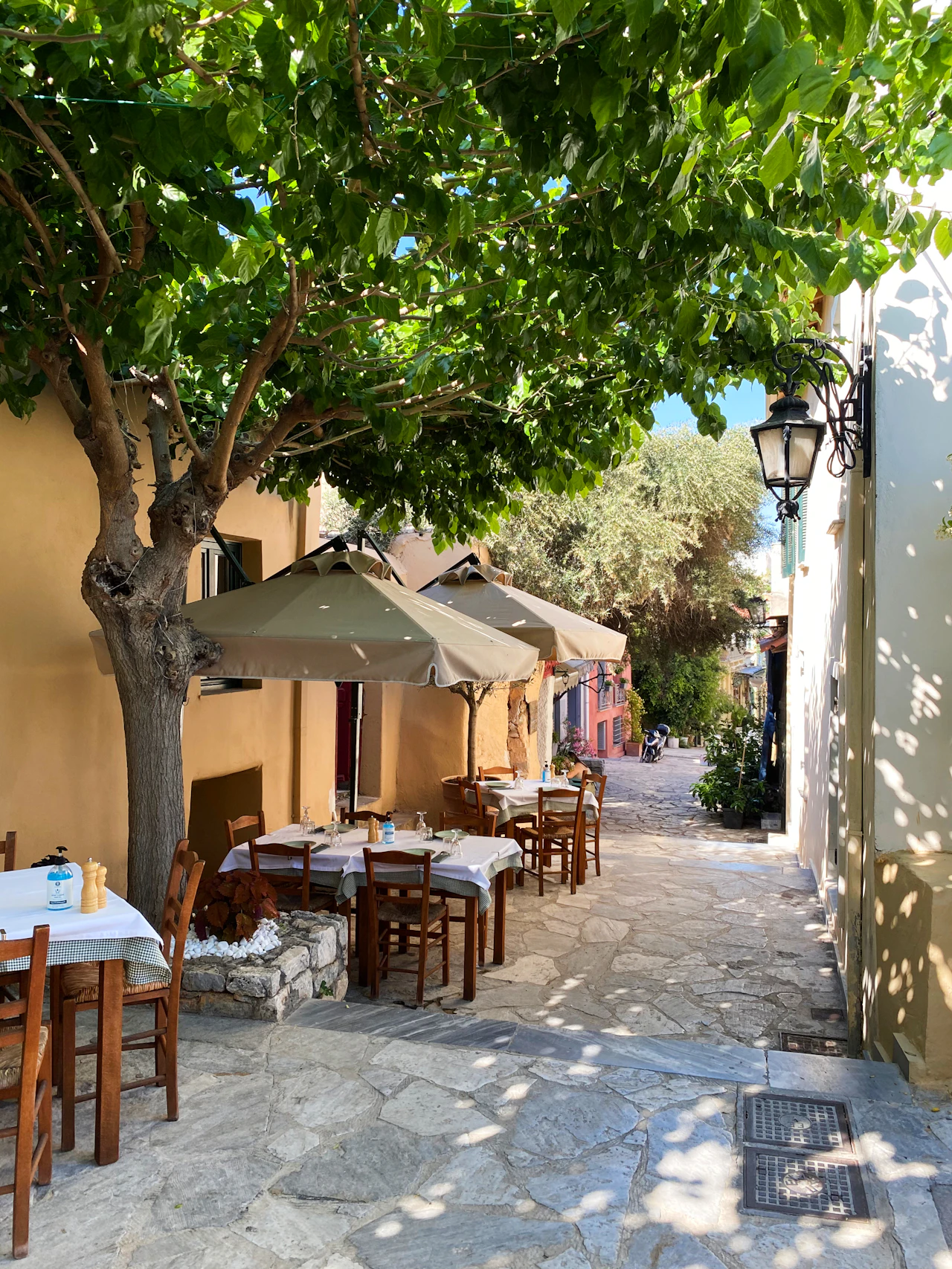 Taverna tables on a quiet cobbled Athens lane