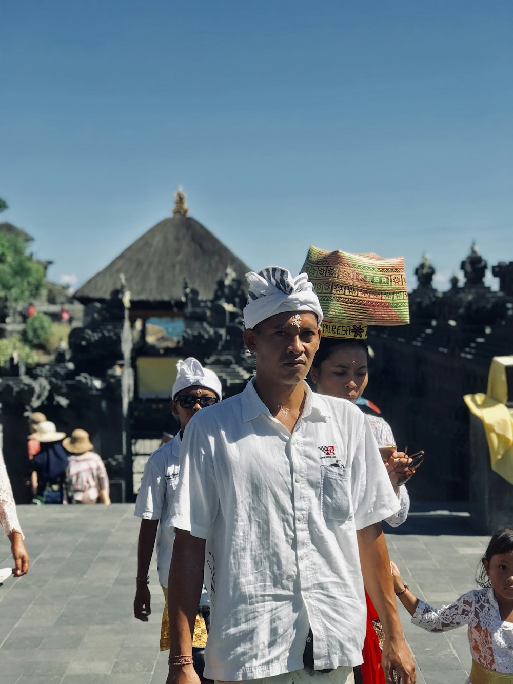 man in white button up t-shirt standing on street during daytime