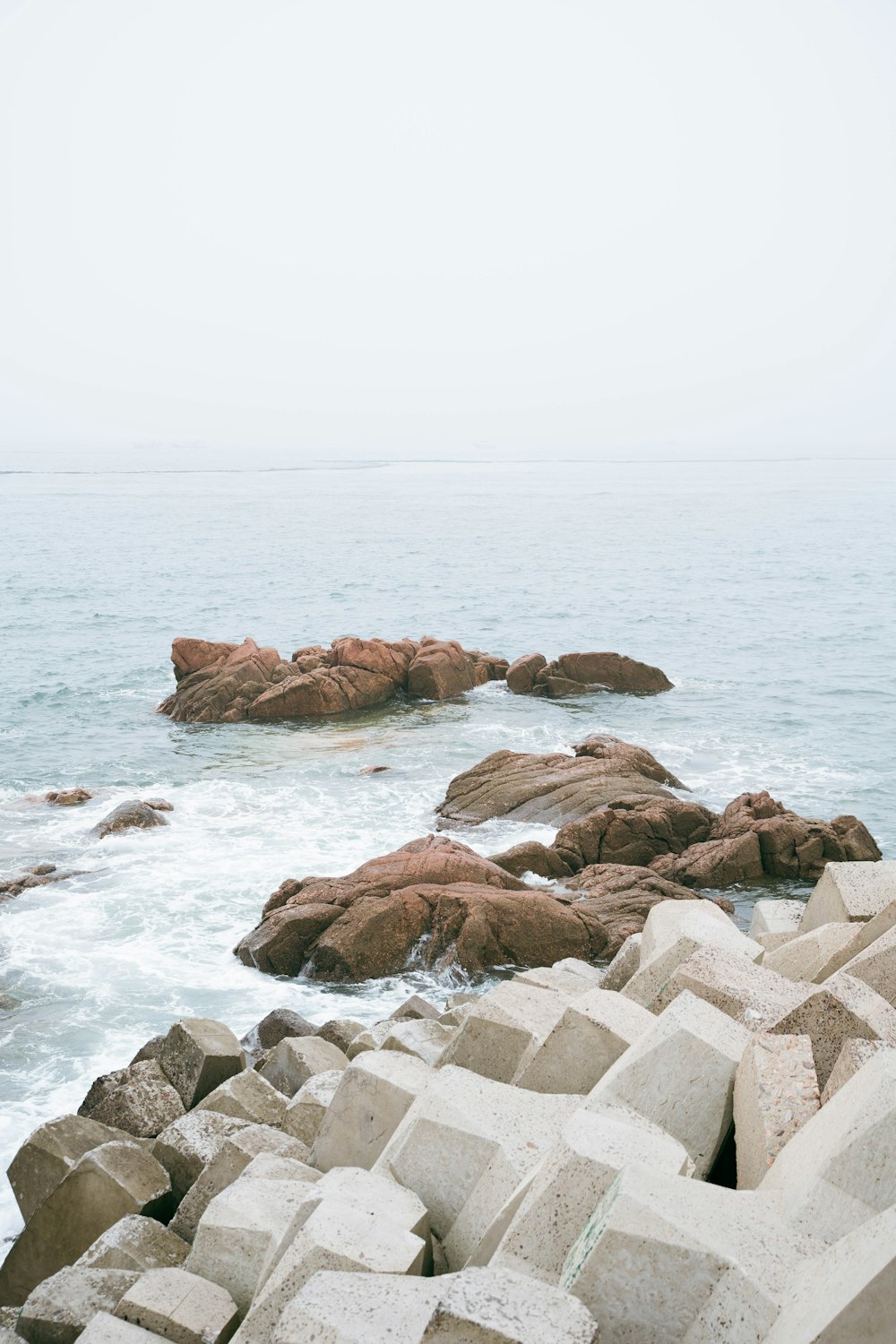 brown rock formation near body of water during daytime