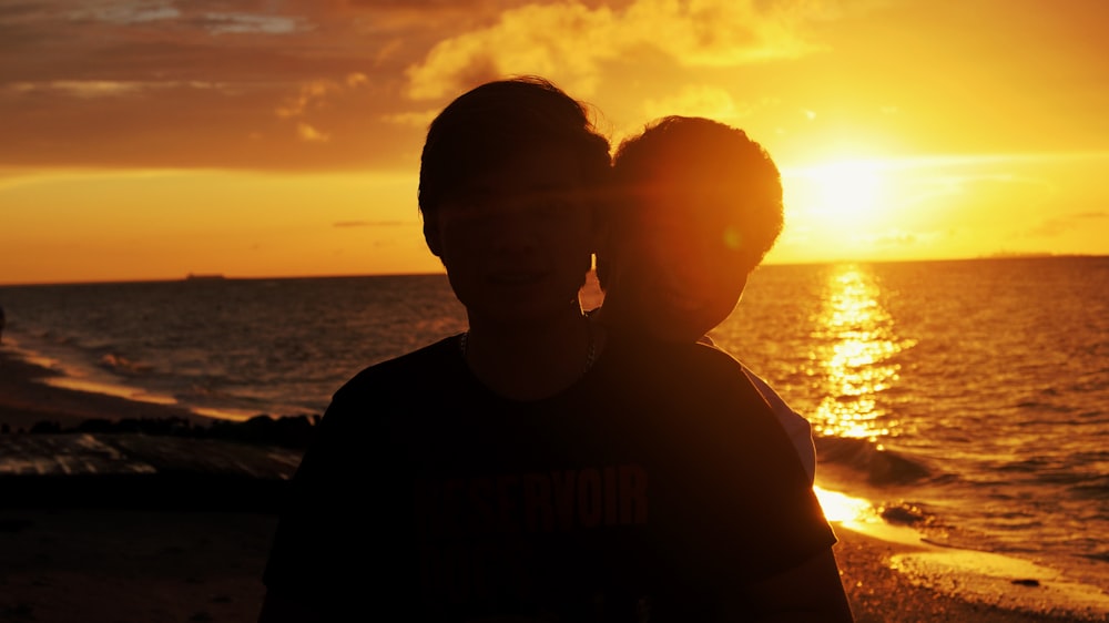 silhouette of man wearing sunglasses during sunset