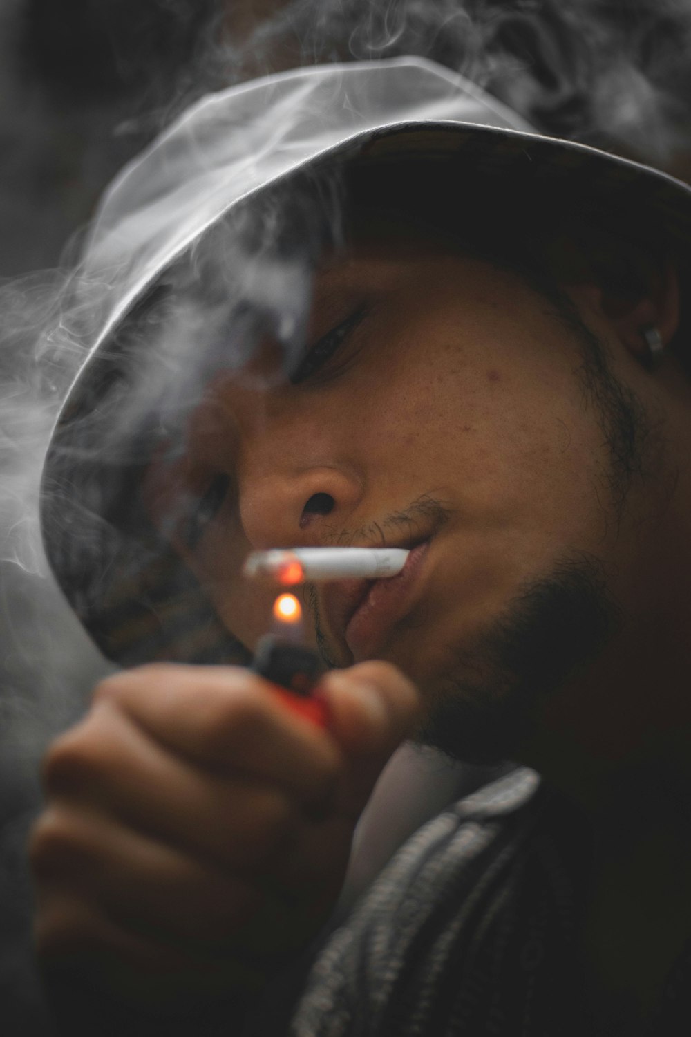 man smoking cigarette in a room