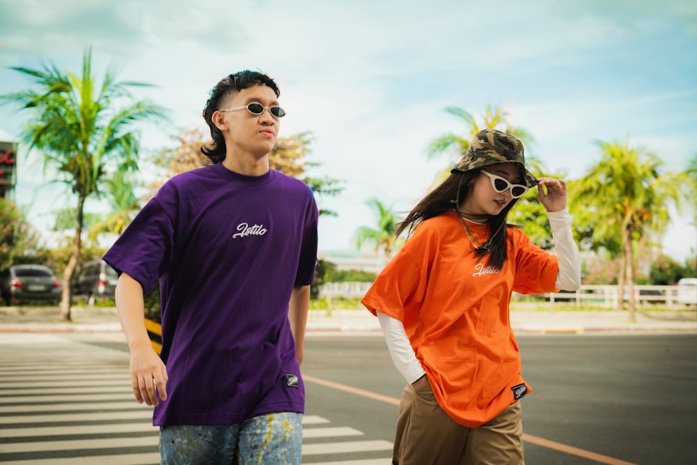 man in black crew neck t-shirt standing beside woman in orange crew neck t-shirt