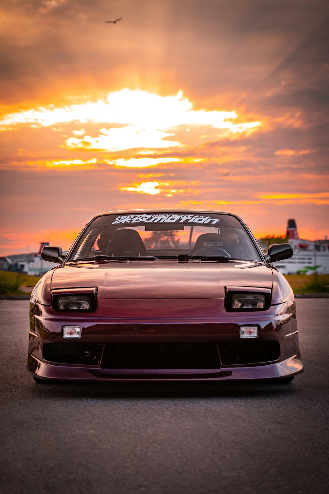 red chevrolet camaro on road during sunset