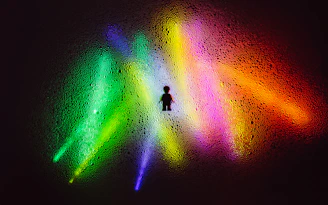 person in black shirt and pants standing on green and orange light