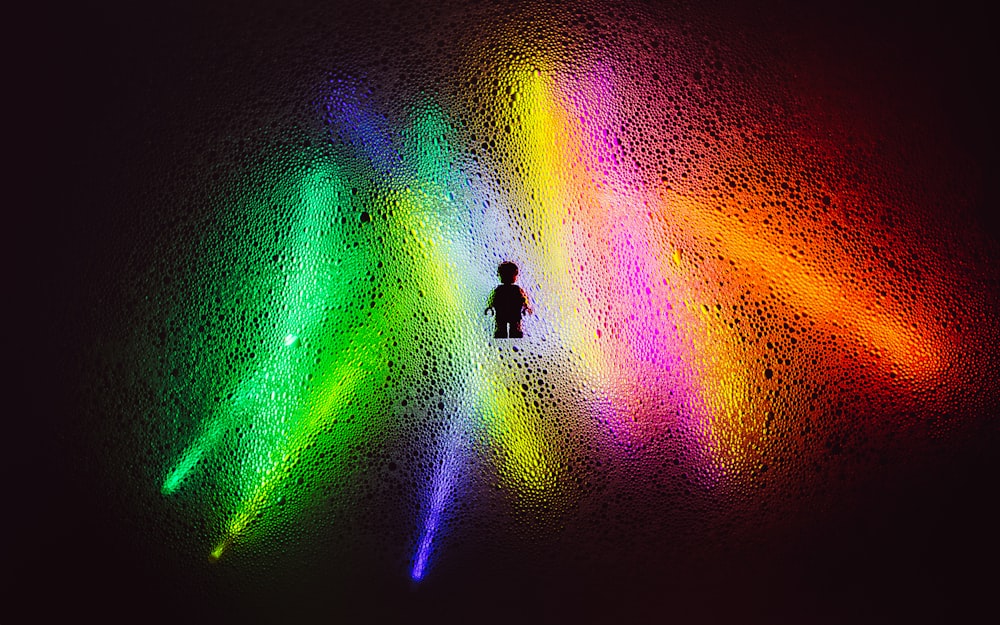 person in black shirt and pants standing on green and orange light