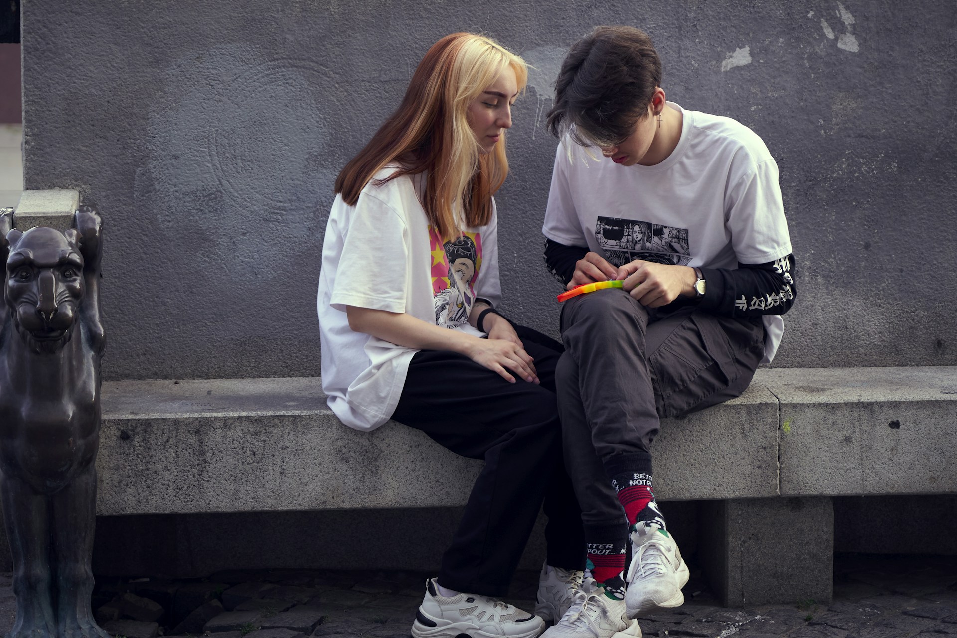 man in white crew neck t-shirt sitting beside woman in white crew neck t-shirt