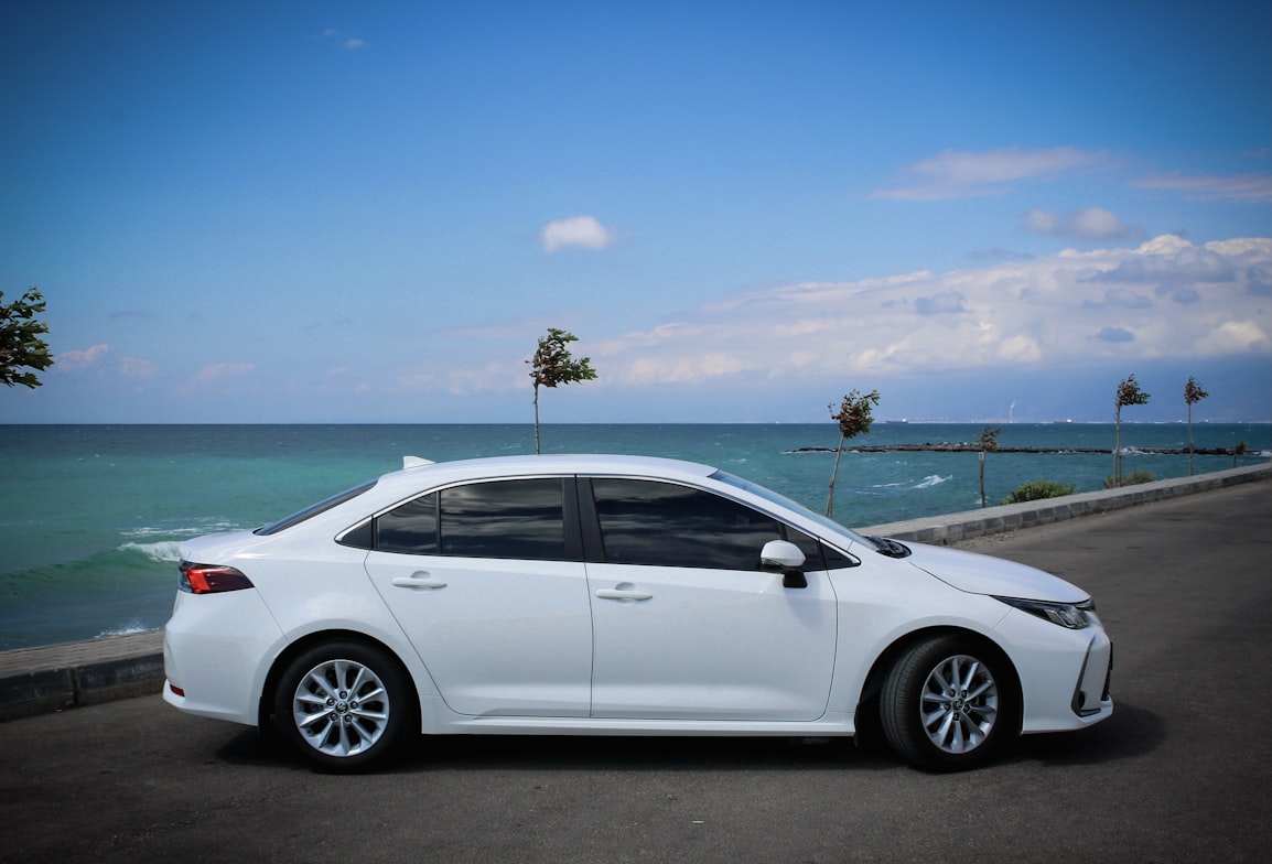 White Toyota Corolla on a beach in Panama City, Florida.