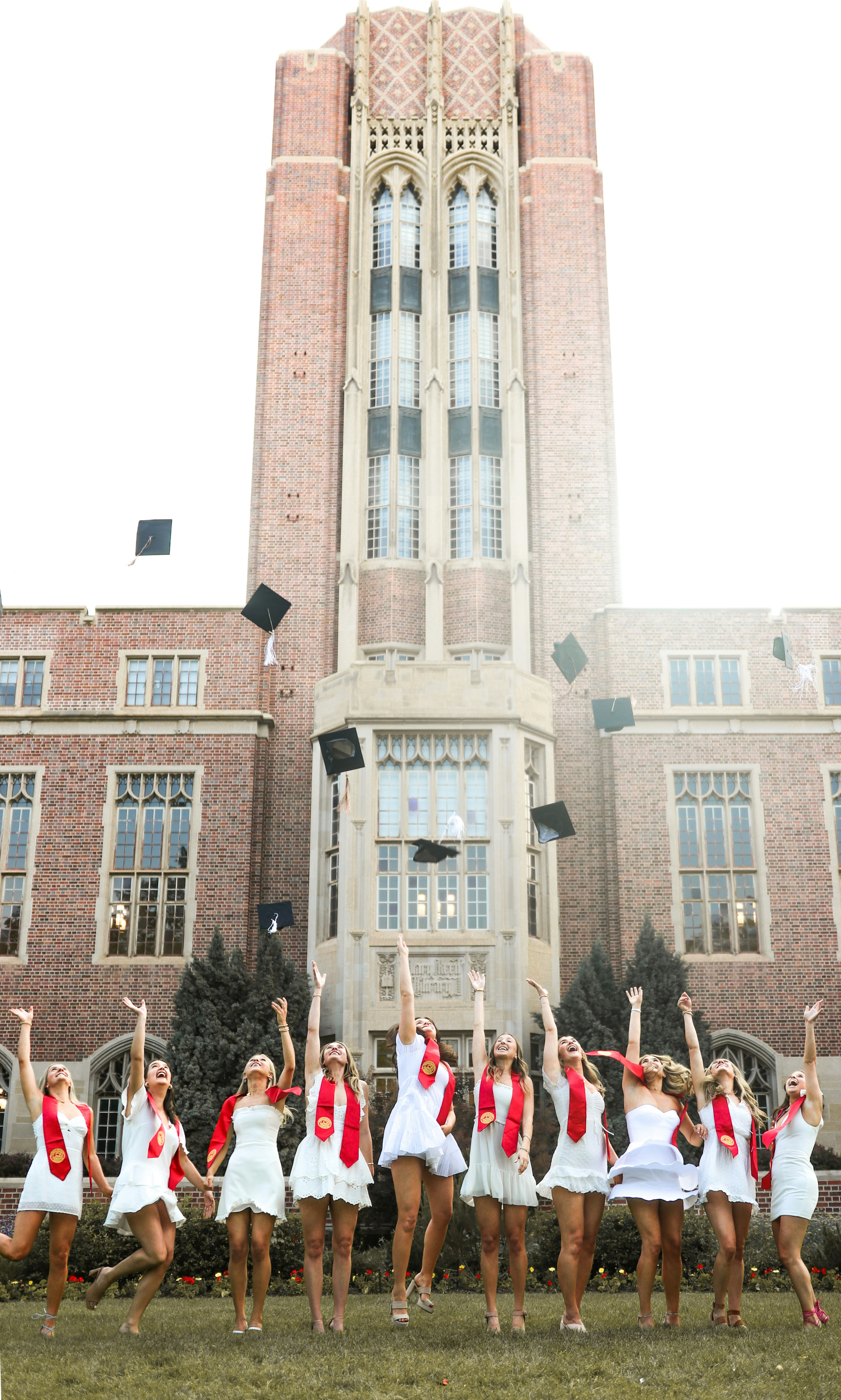 people in red and white shirts standing near brown concrete building during daytime