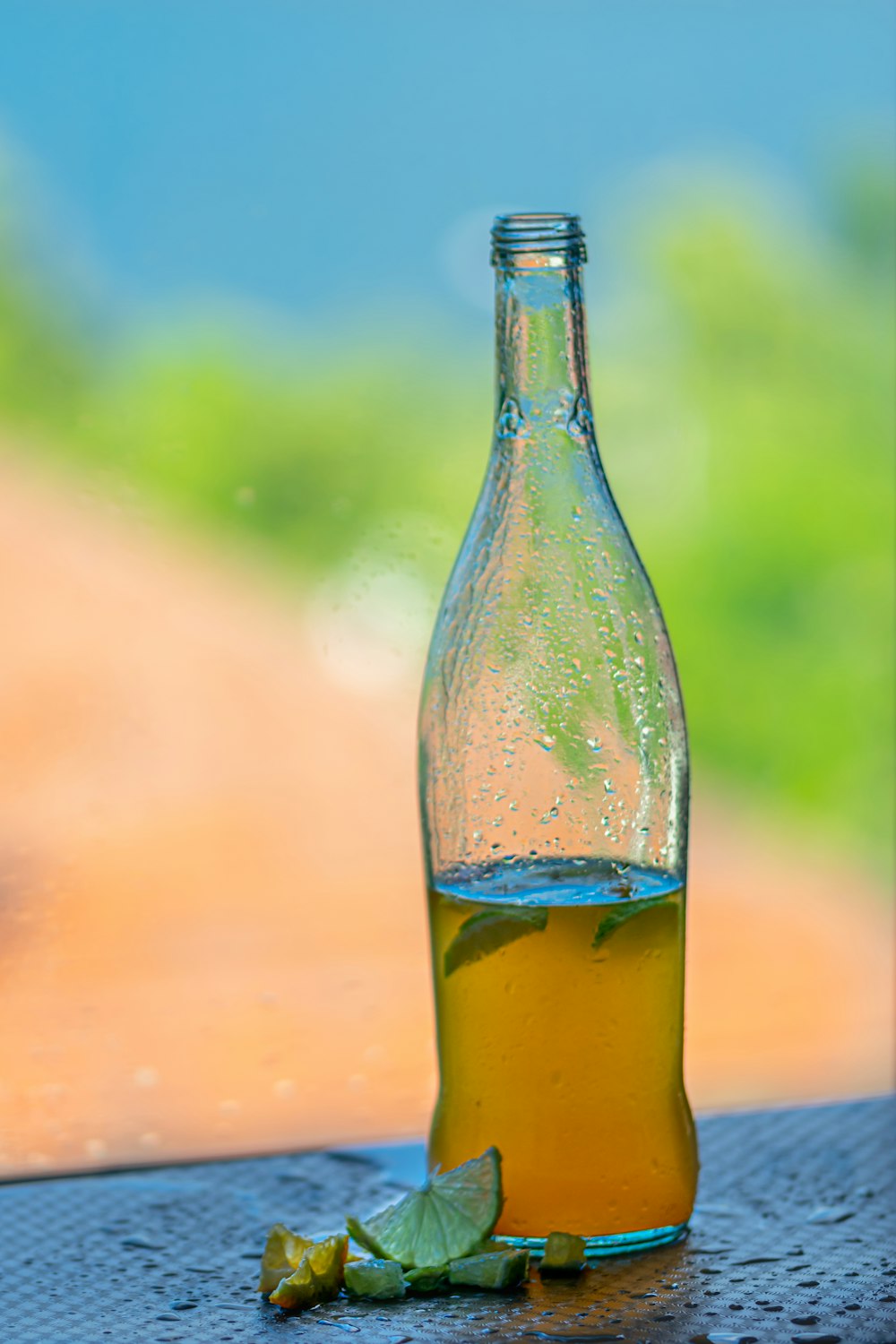 clear glass bottle with yellow liquid
