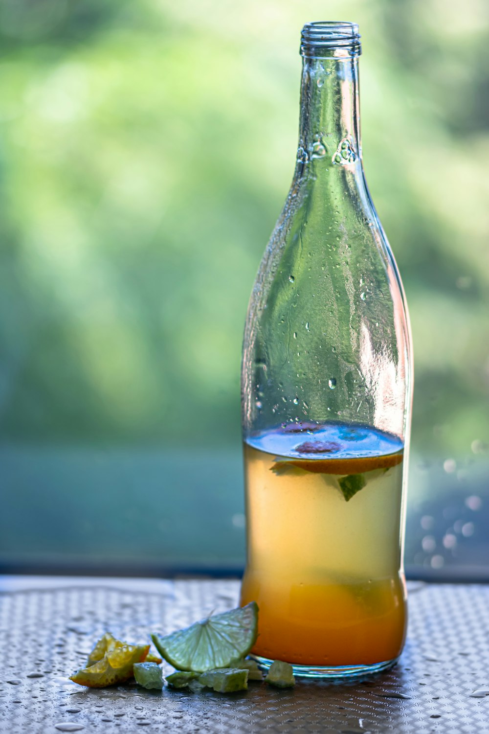 clear glass bottle with yellow liquid