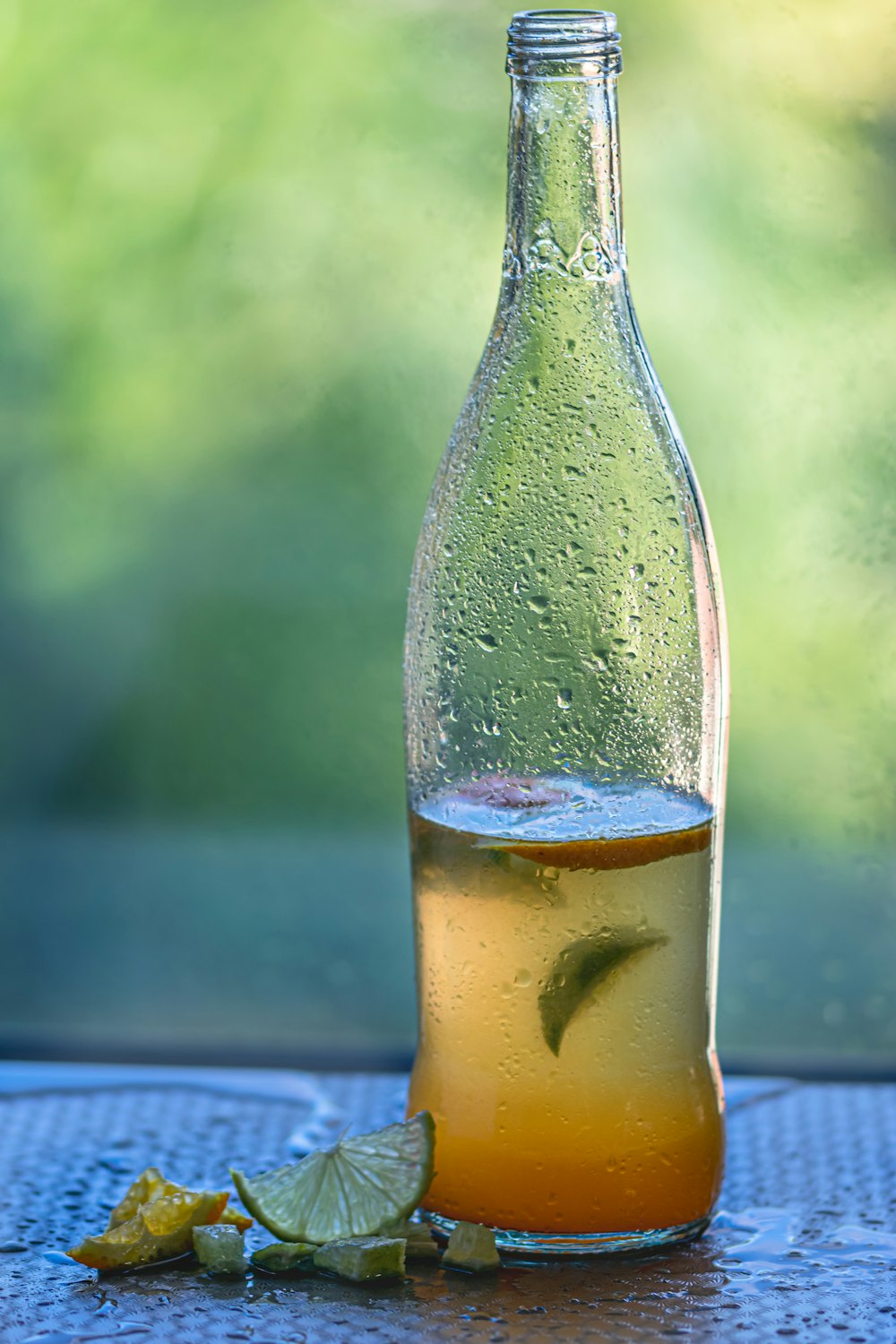 clear glass bottle with yellow liquid