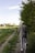 man in black jacket riding bicycle on green grass field during daytime