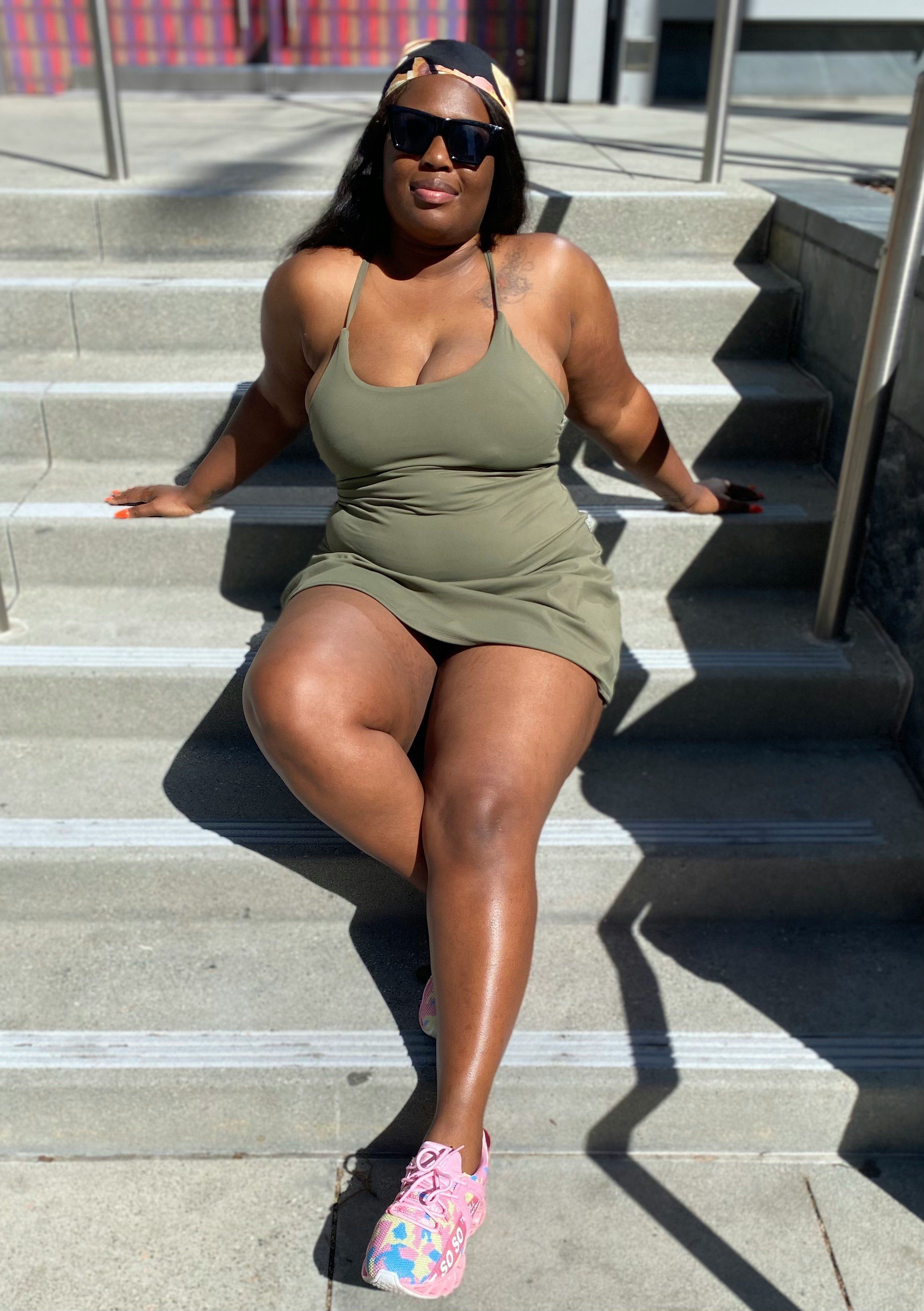 woman in white tank top sitting on stairs