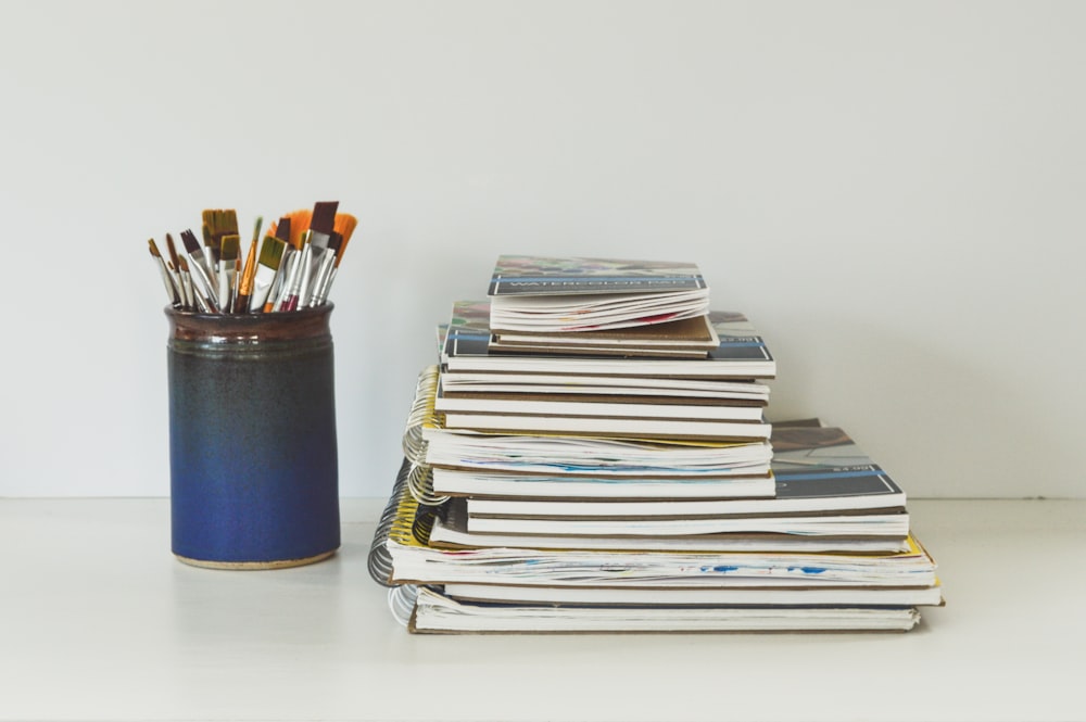 blue and white books on white table