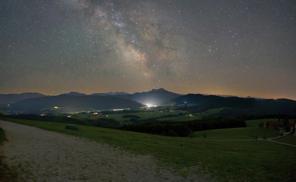 green grass field under starry night