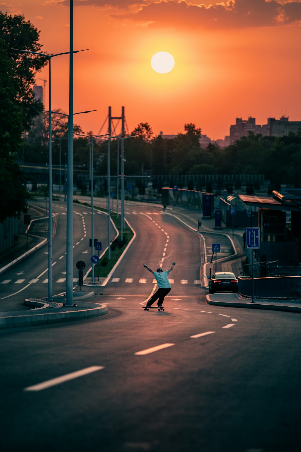 man in black jacket and black pants riding on black skateboard during night time