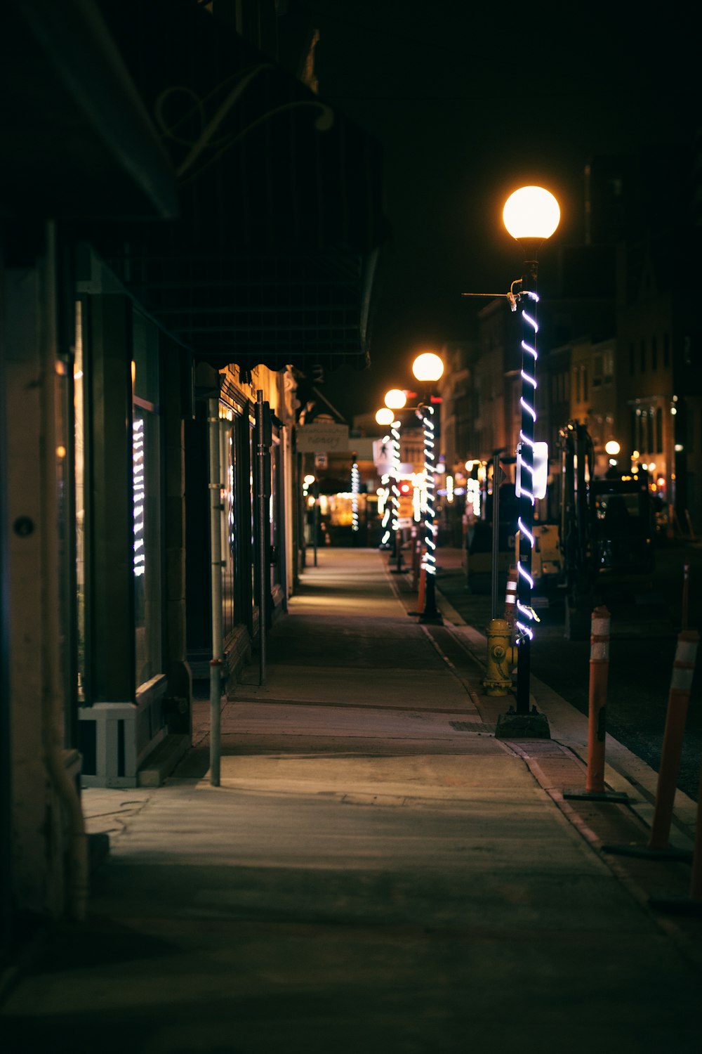 people walking on sidewalk during night time