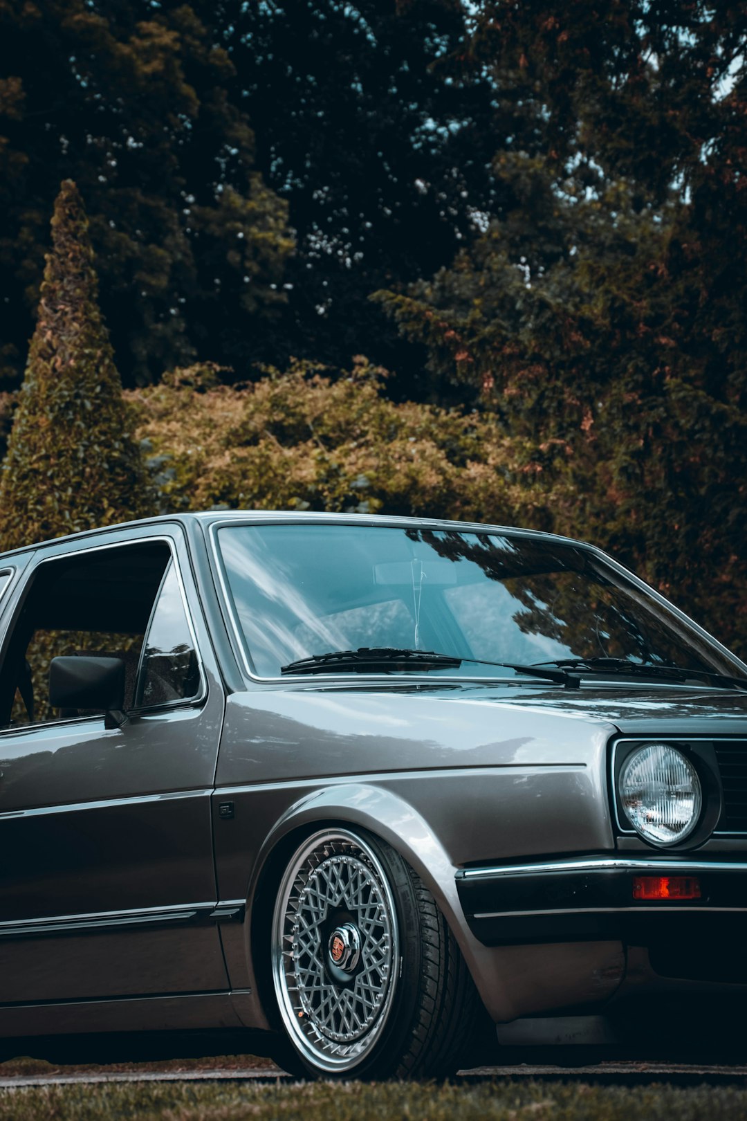 black mercedes benz c class parked near brown trees during daytime