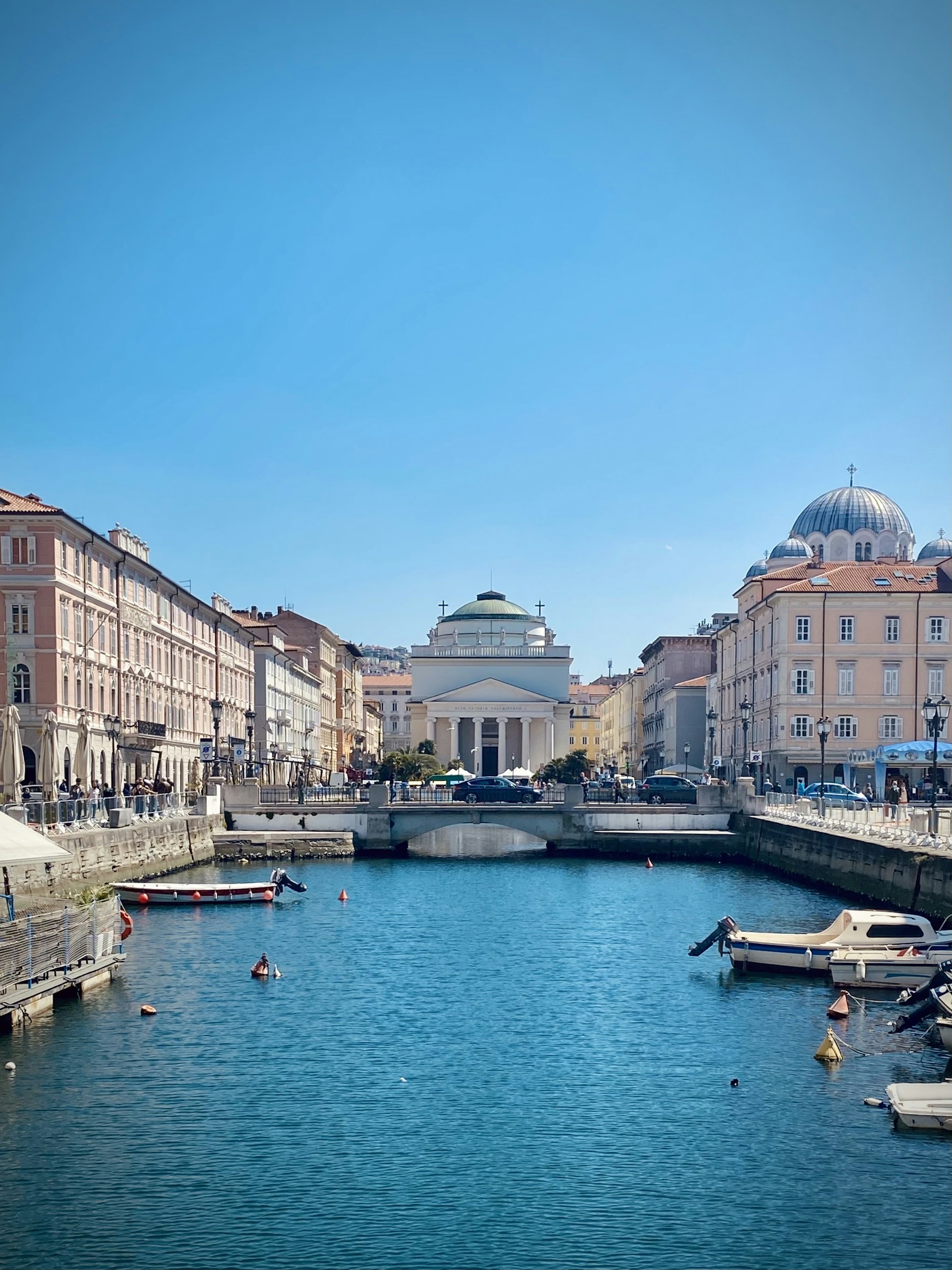 white and brown concrete building near body of water during daytime