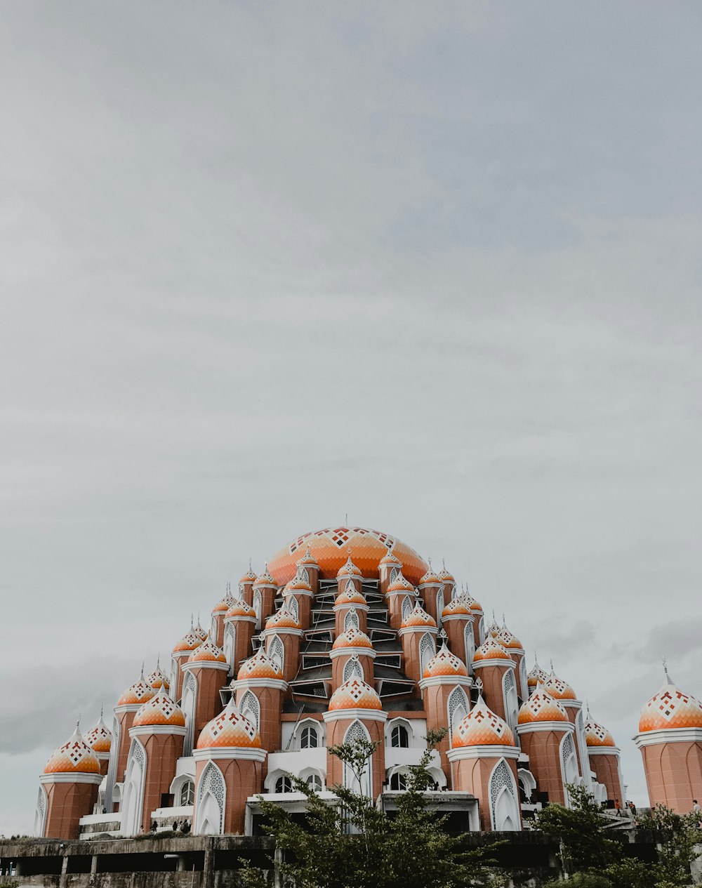 orange and white dome building under white sky during daytime