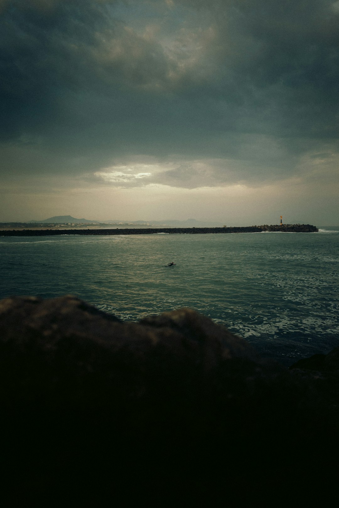 body of water under cloudy sky during daytime