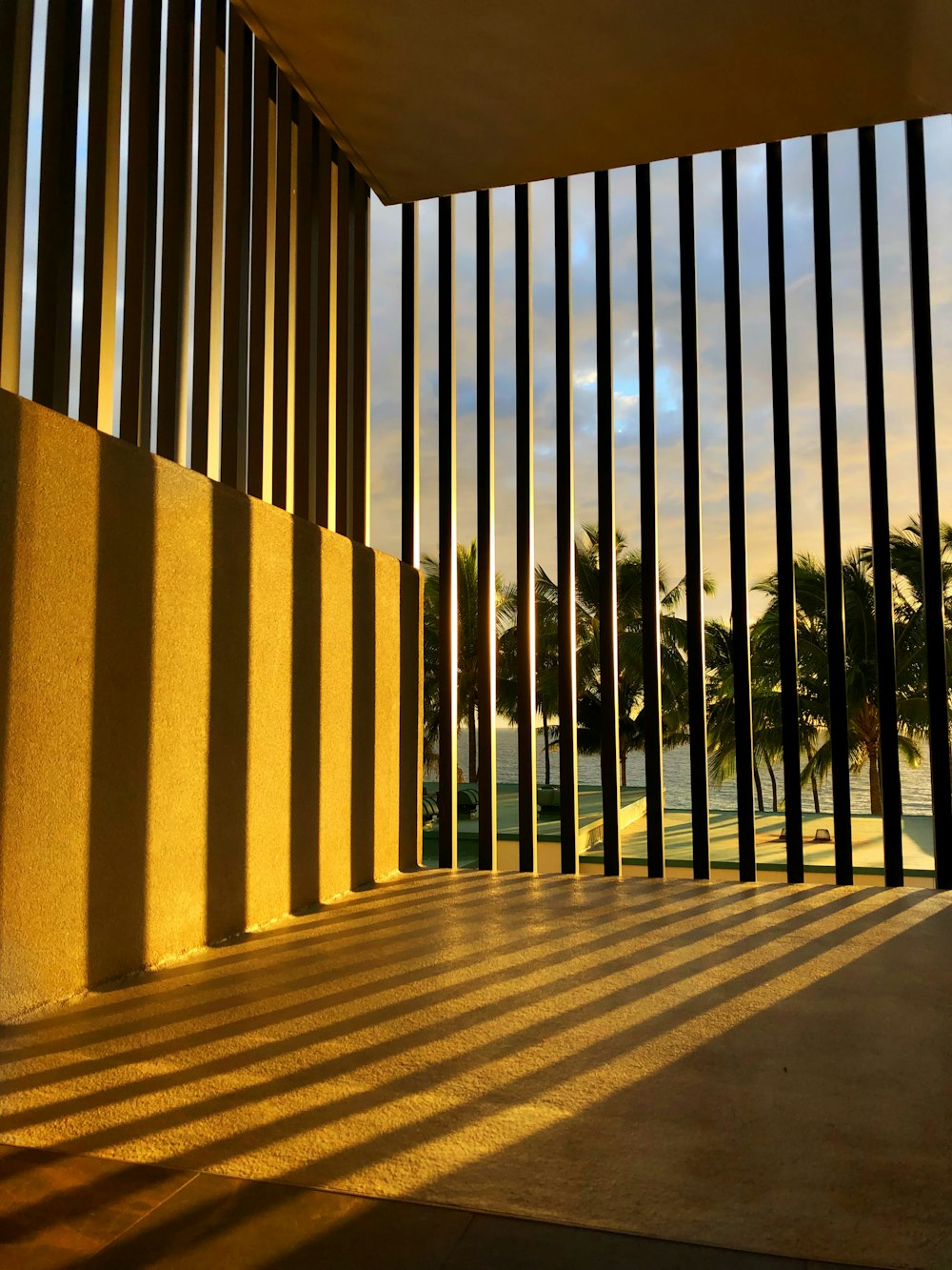 brown concrete building with black metal fence