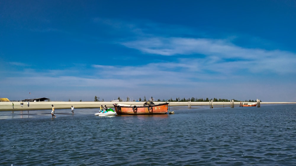 brown boat on sea under blue sky during daytime