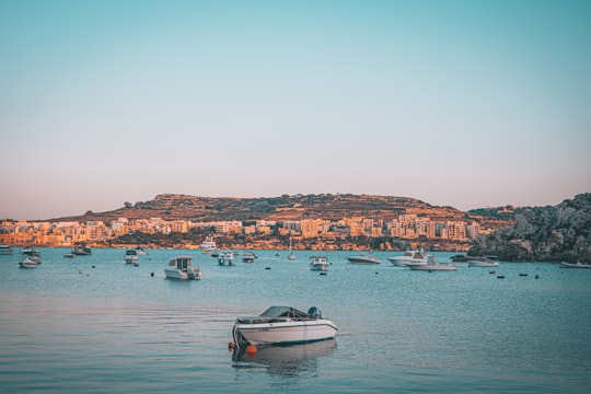 white and black boat on sea during daytime in Mistra Bay Malta