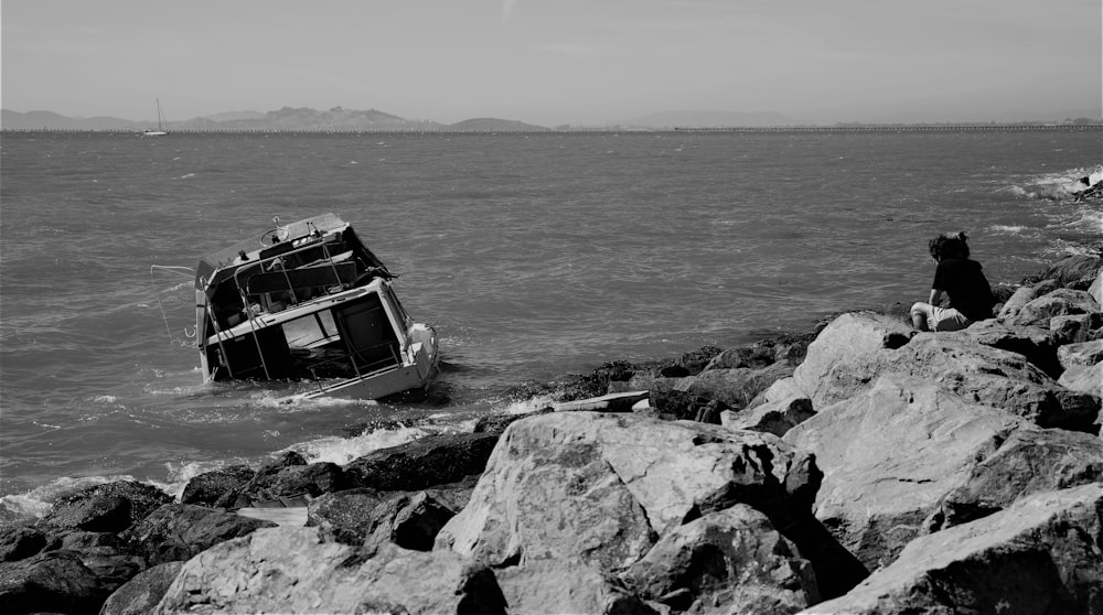 grayscale photo of a boat on the sea