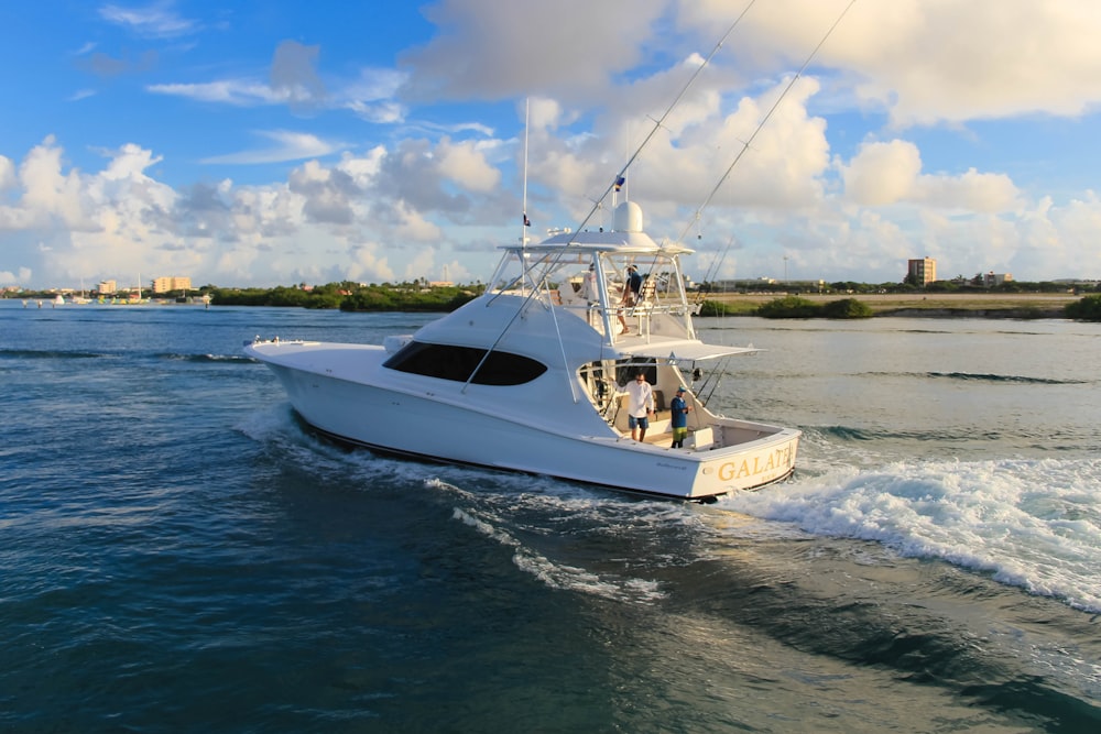 white and blue boat on sea during daytime