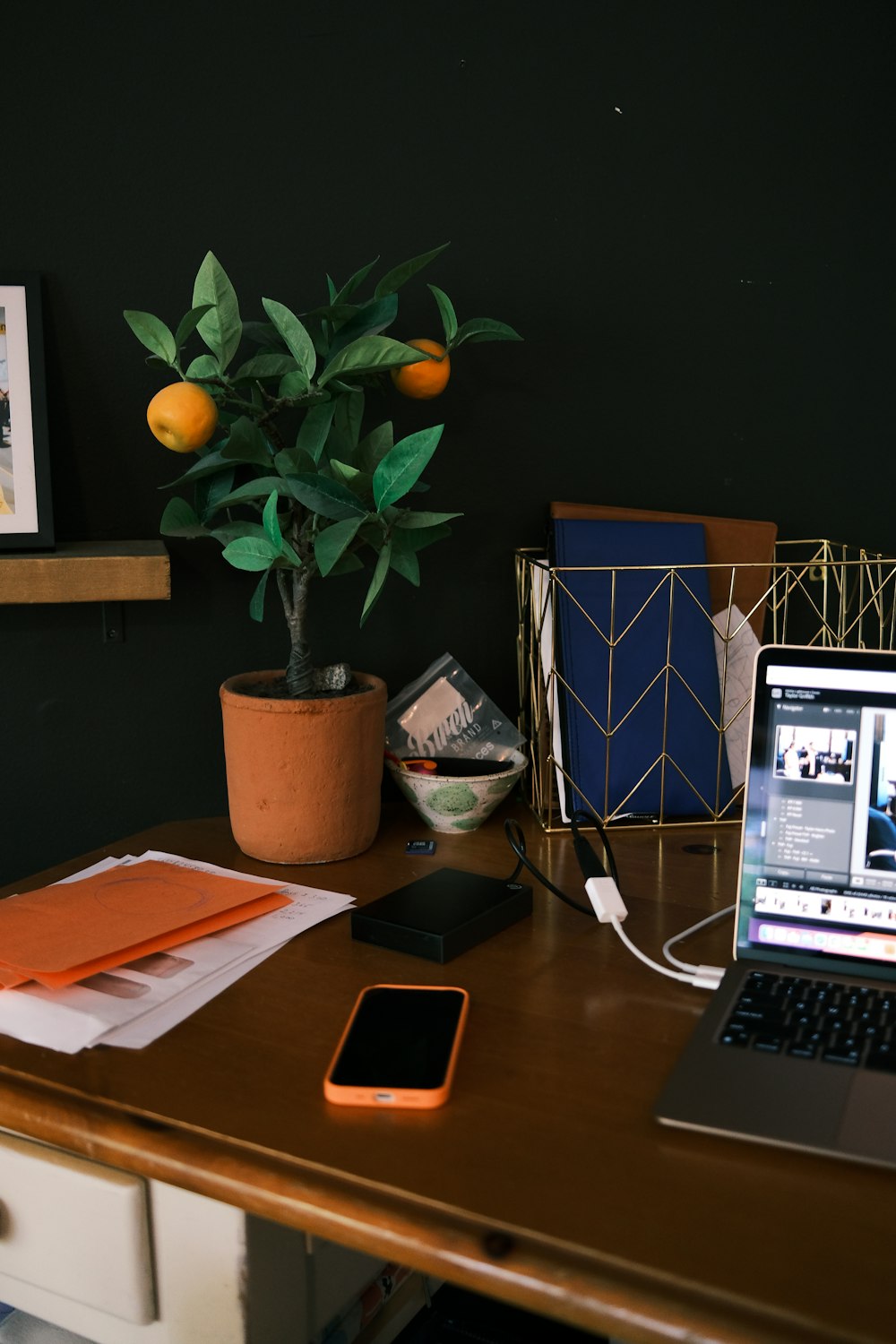 silver iphone 6 beside macbook pro on brown wooden table