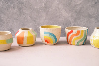 Close-up of colorful ceramic cups with unique hand-painted designs.