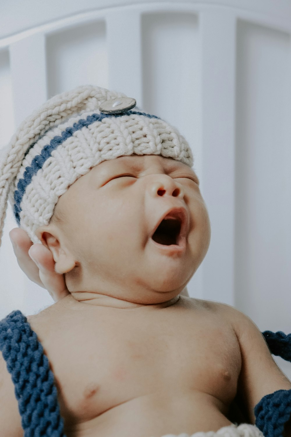 baby wearing white knit cap