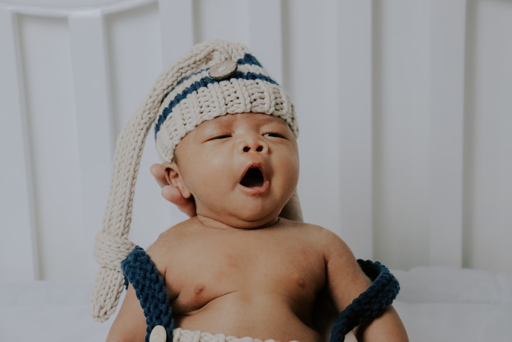 baby wearing white knit cap