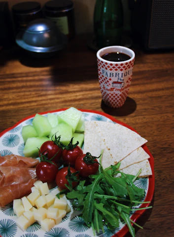 A cozy kitchen scene with fresh dairy products and cold cuts arranged invitingly on a wooden table.