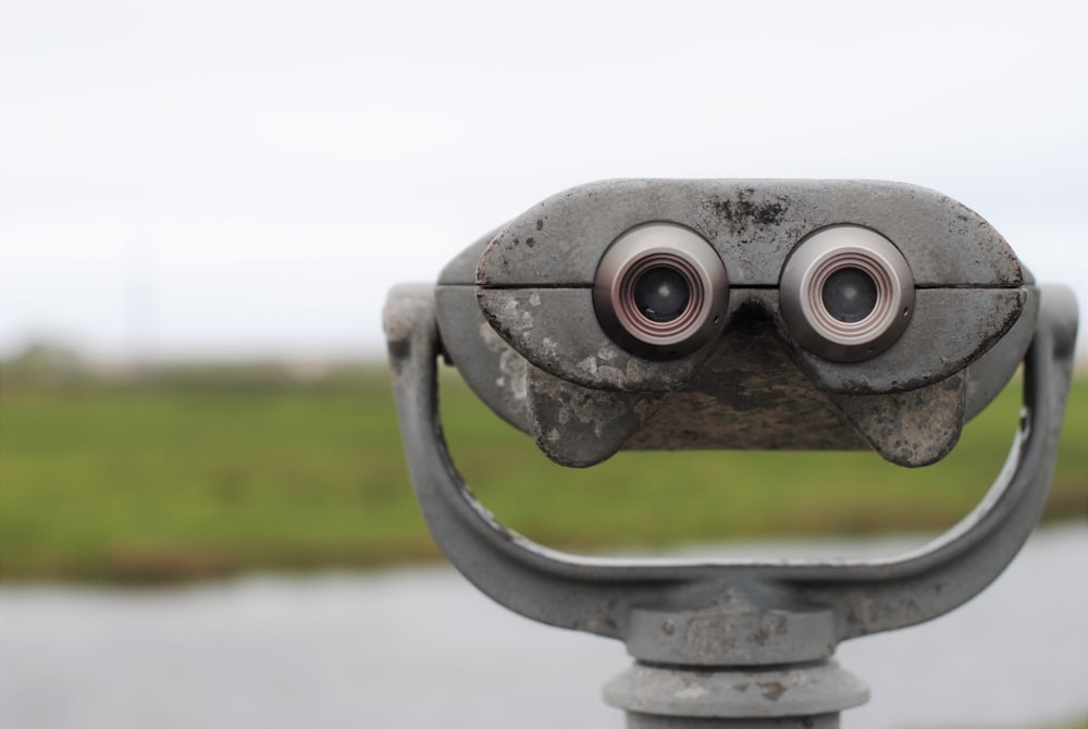 black and gray binoculars on green grass field during daytime