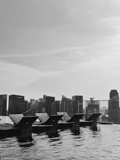 An infinity pool with panoramic views of a glittering skyline at dusk.