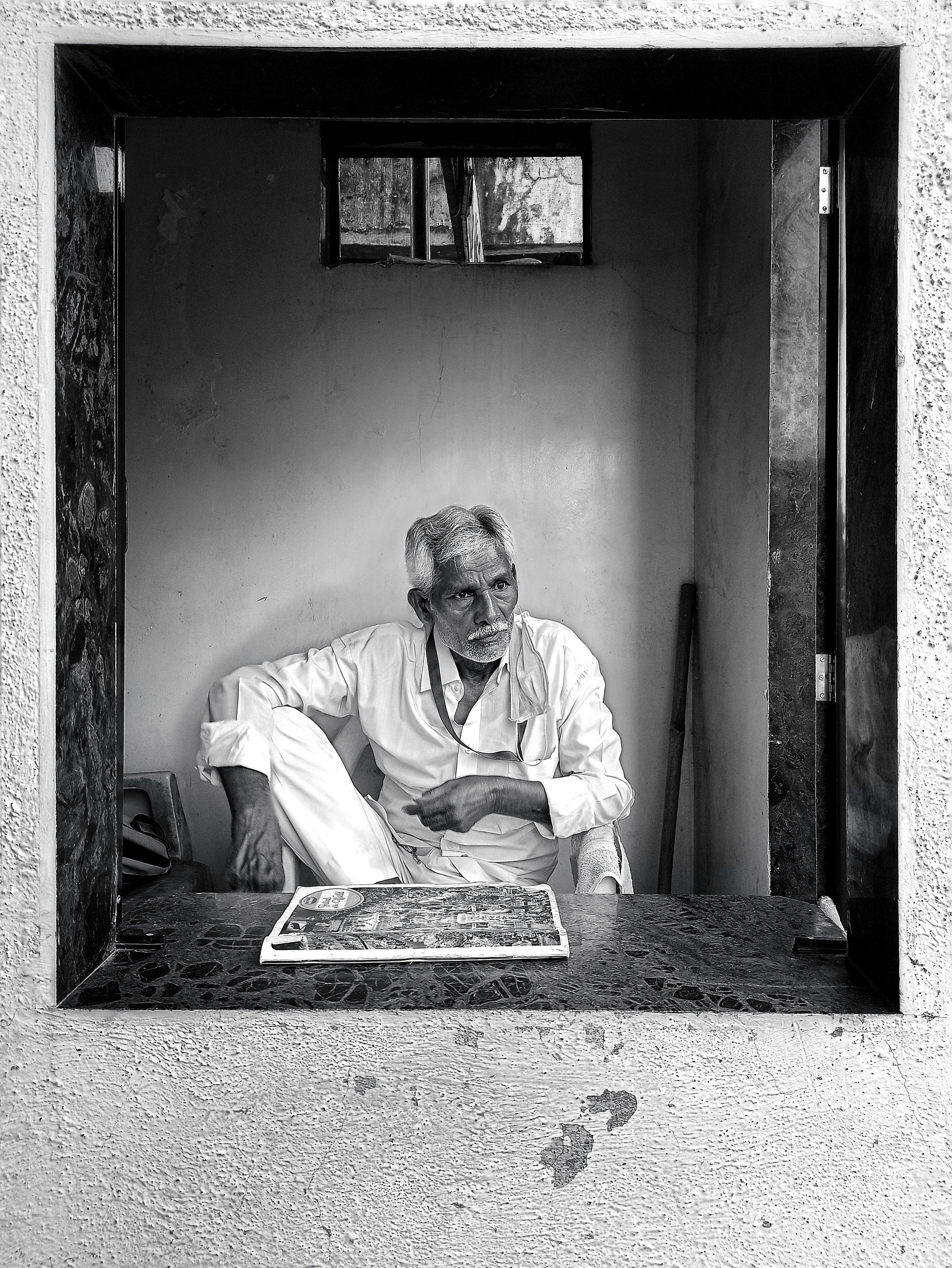 man in white dress shirt sitting on the floor
