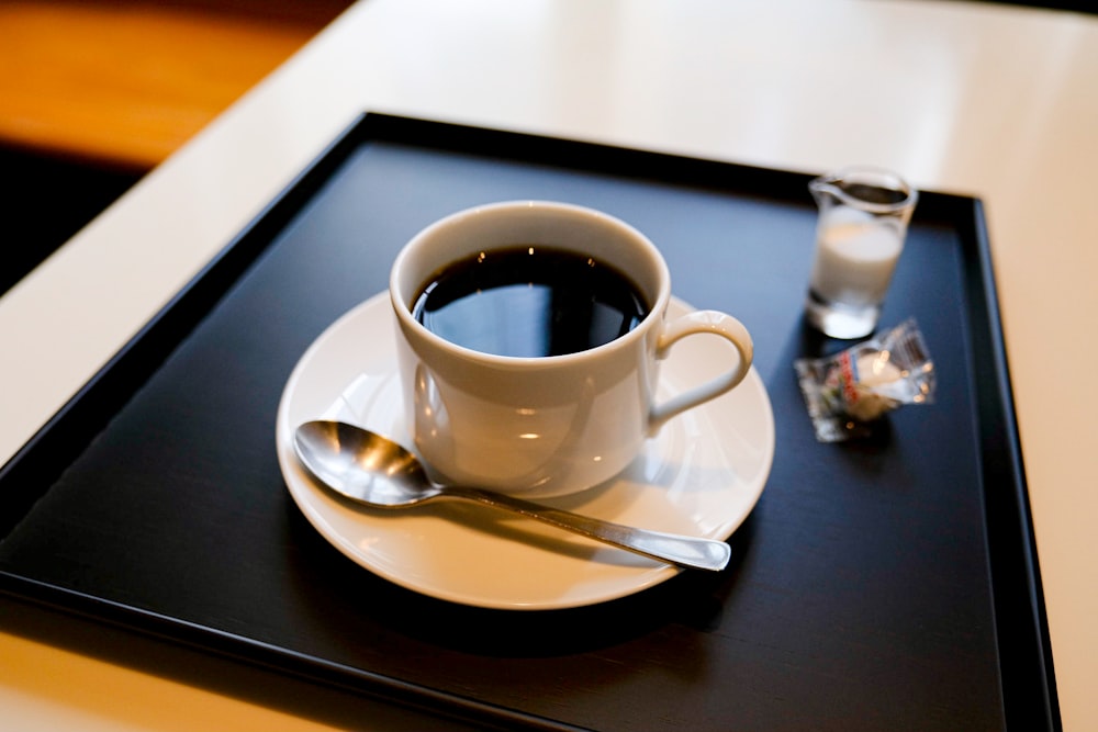 white ceramic cup on saucer