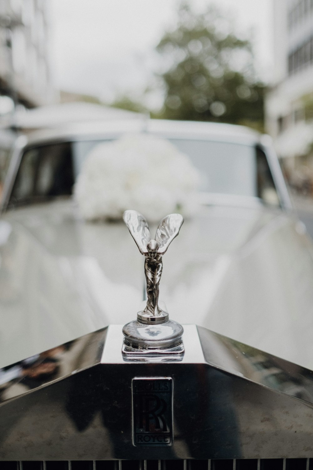 silver angel figurine on car