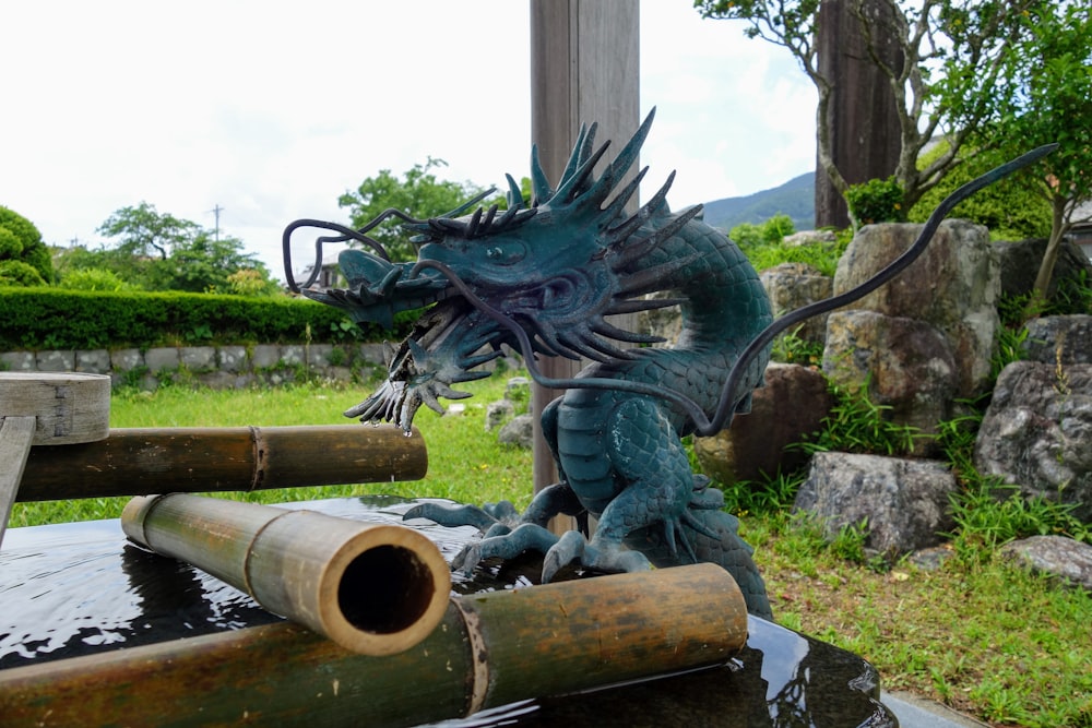 black dragon statue on brown wooden stand