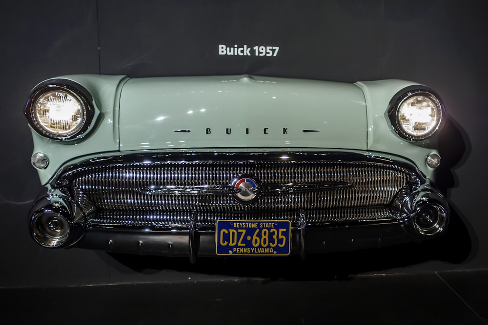 white classic car in a dark room