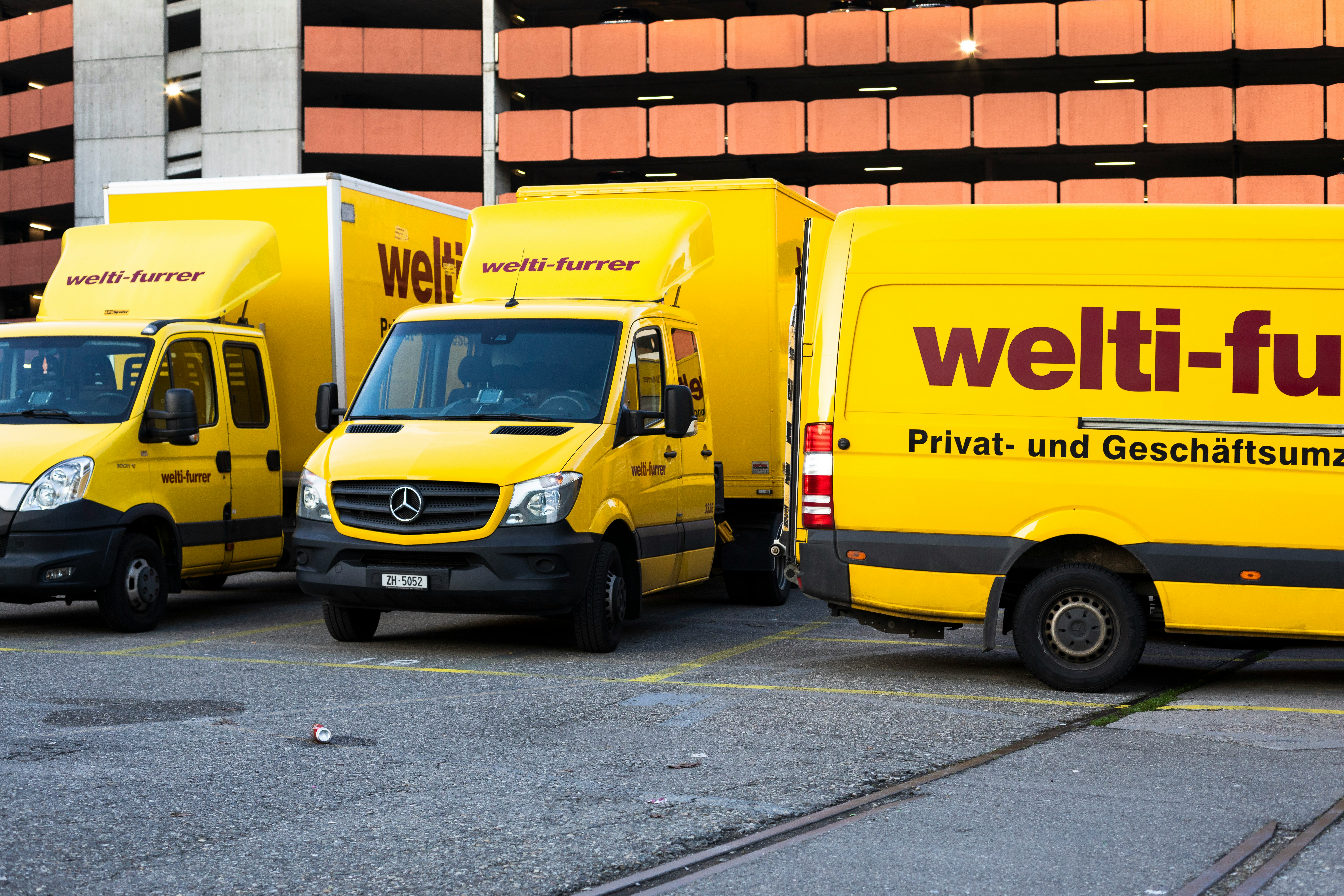 yellow and black volkswagen t-2 parked on gray concrete road during daytime