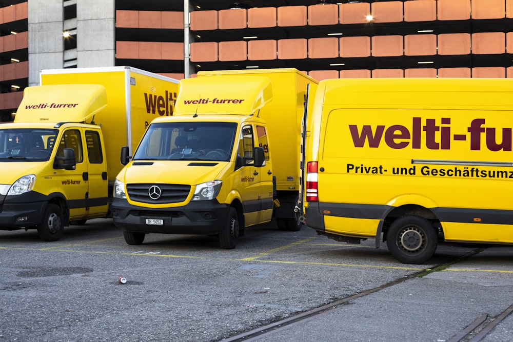 yellow and black volkswagen t-2 parked on gray concrete road during daytime