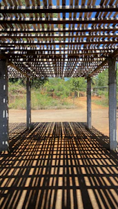 A sleek pergola shade casting cool shadows over a modern patio.